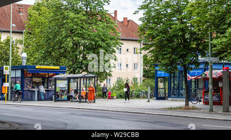 Imbiss fast food kiosk, busstop and U-bahn underground railway station entrance on Breitenbachplatz, Dahlem, Berlin Stock Photo