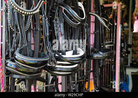 90th Kent County Show, Detling, 6th July 2019. Bridles hanging up on a display rack. Stock Photo