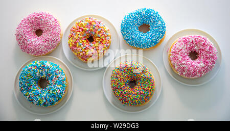 Assorted donuts. Colorful donuts assortment on white color background. Top view Stock Photo