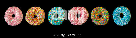 Assorted donuts. Colorful donut collage isolated on black color background. Top view, banner Stock Photo