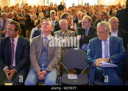 Sonneberg, Germany. 07th July, 2019. Joachim Herrmann (CSU, r), Deputy Bavarian Prime Minister, and Bodo Ramelow (Linke, M), Thuringia's Prime Minister, are not sitting next to each other during the ceremony Thuringia-Bavaria will have at the 'Day of the Franks 2019', which for the first time will also take place in the Franconian-influenced Thuringian region. The former Federal Minister of Agriculture, Hans-Peter Friedrich (CSU), also sits next to him. Credit: dpa picture alliance/Alamy Live News Stock Photo