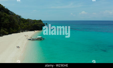 Tropical beach with palm trees and turquoise waters of the coral reef, top view, Puka shell beach. Boracay, Philippines. Seascape with beach on tropical island. Summer and travel vacation concept. Stock Photo