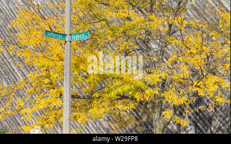 Downtown crossroads of Saginaw, Michigan with vibrant autumn foliage in the background Stock Photo