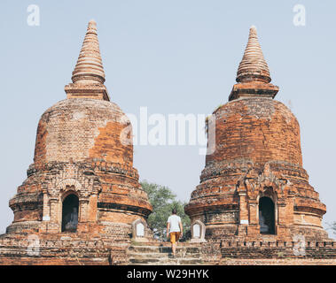 Man entering the ruins of old temple in Bagan, Myanmar. Wide angle shot. Stock Photo