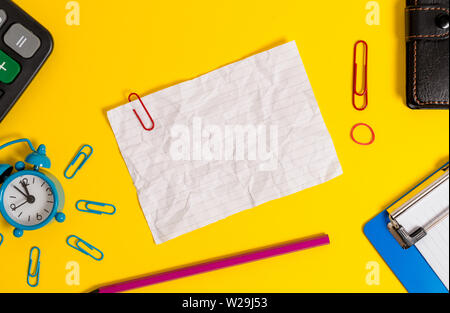 Alarm clock clipboard calculator wallet clip band pencil crushed sheet Stock Photo