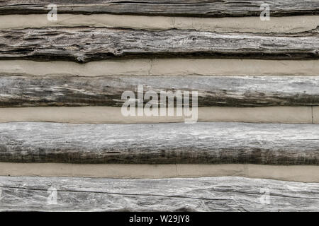 Old Log Cabin Wall Background. Close up of exterior traditional log cabin wall. Stock Photo