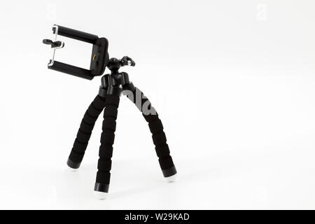 Mini tripod for smartphone on a white background Stock Photo