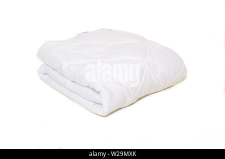 Rolled white duvet cover on white isolated background Stock Photo