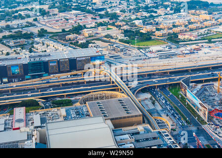 Dubai, United Arab Emirates - July 5, 2019: Roads and streets of Dubai downtown leading to Dubai mall parking top view