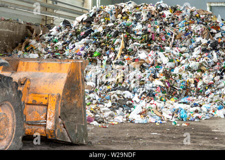 Minsk, Belarus -June 6, 2019 Pile of plastic bottles, paper and polyethylene at a waste recycling plant before sorting. Stock Photo
