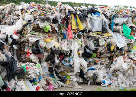 Minsk, Belarus -June 6, 2019 A pile of pressed polyethylene at a garbage collection plant. Sorting and processing of polyethylene. The concept of envi Stock Photo