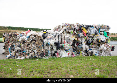 Minsk, Belarus -June 6, 2019 A pile of pressed polyethylene at a garbage collection plant. Sorting and processing of polyethylene. The concept of envi Stock Photo