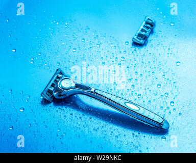 Blade shaving and reserve on a blue surface. Commercial product presentation Stock Photo