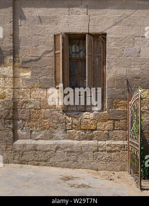 Broken windows and grunge stone bricks wall in abandoned Darb El Labana district, Cairo, Egypt Stock Photo