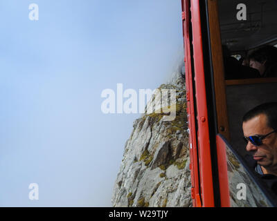 View from Cog Railway, Mount Pilatus, Lucerne, Switzerland - man looking out Stock Photo