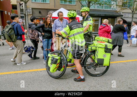 BC Ambulance Service paramedics on bicycles, Khatsahlano Street Festival, Kitsilano, Vancouver, British Columbia, Canada Stock Photo