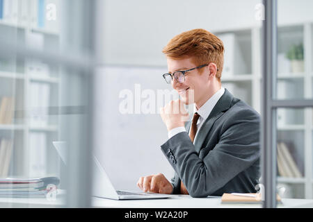 Young successful analyst or financier working with online data Stock Photo