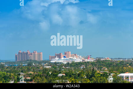 Nassau, Bahamas - February 28, 2018:  Cruise ships anchored in the Port of Nassau, an island filled with resorts and cruise ship passengers. Stock Photo