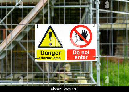 Health and safety hazard signs outside entrance to construction site ...