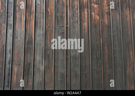 Natural dark stained wood building wall background. Stock Photo