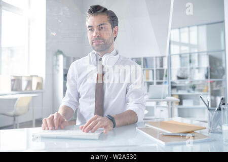 Young confident designer looking at computer screen Stock Photo
