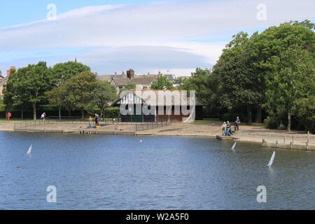 Enthusiasts sailing radio controlled model boats from Barrow-In-Furness Town Park, Cumbria UK. Stock Photo