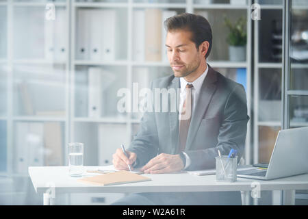 Young elegant businessman concentrating on work Stock Photo