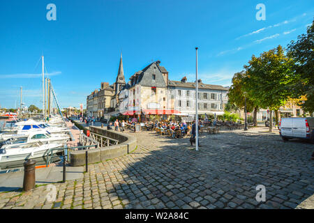 The colorful village of Honfleur France on the coast of Normandy with it's old harbor, timber frame homes and sidewalk cafes Stock Photo