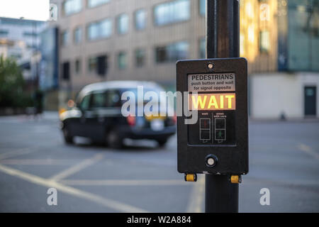 London cross lights with crossing light 'Wait' sign Stock Photo