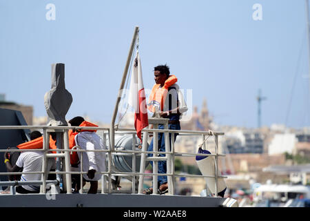 Floriana, Malta. 7th July, 2019. Rescued migrant wait for disembarkation in Floriana, Malta, on July 7, 2019. A group of 58 migrants was rescued by the Armed Forces of Malta (AFM) on Sunday morning. Credit: Jonathan Borg/Xinhua/Alamy Live News Stock Photo