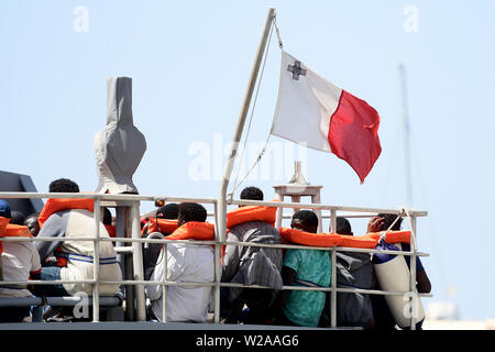 Floriana, Malta. 7th July, 2019. A rescued migrant (3rd R) turns his head and looks out from the deck as the Armed Forces of Malta patrol boat P21 arrives in Floriana, Malta, on July 7, 2019. A group of 58 migrants was rescued by the Armed Forces of Malta (AFM) on Sunday morning. Credit: Jonathan Borg/Xinhua/Alamy Live News Stock Photo