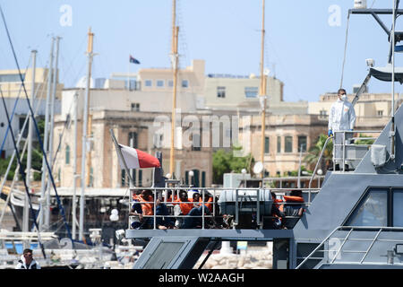 Floriana, Malta. 7th July, 2019. Rescued migrants are seen on the deck of the Armed Forces of Malta patrol boat P21, in Floriana, Malta, on July 7, 2019. A group of 58 migrants was rescued by the Armed Forces of Malta (AFM) on Sunday morning. Credit: Jonathan Borg/Xinhua/Alamy Live News Stock Photo