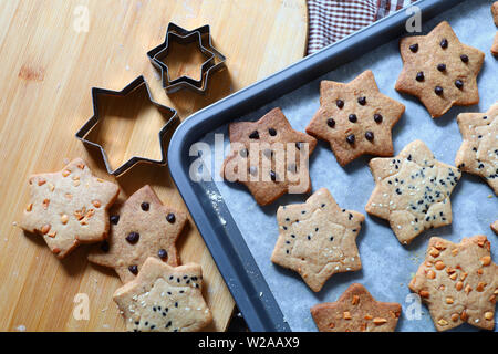 Homemade star shape cookies on baking tray Stock Photo