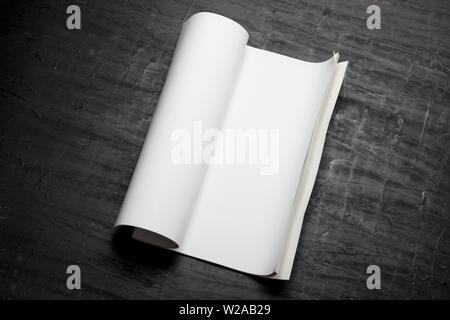 Rolled Up Book on Wooden Background Stock Photo
