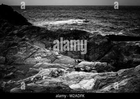 Black and white dramatic rock formations on California coast. Stock Photo