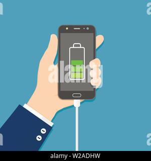 Human hand holding mobile phone with charger connected Stock Vector