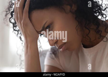 Depressed upset young african woman feeling lonely abused and hurt Stock Photo