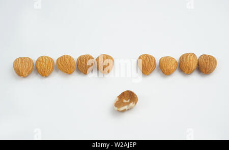 good and bad almonds isolated on white background Stock Photo