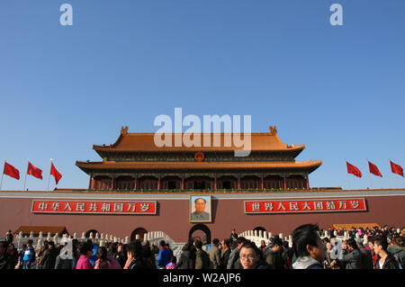 People in front of the Gate of Heavenly Peace in Tiananmen Square, Beijing, China. Tiananmen Square is a Beijing landmark visited by tourists. Stock Photo