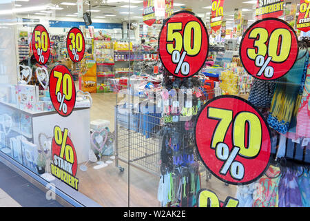 Discount signs on a shop window Stock Photo