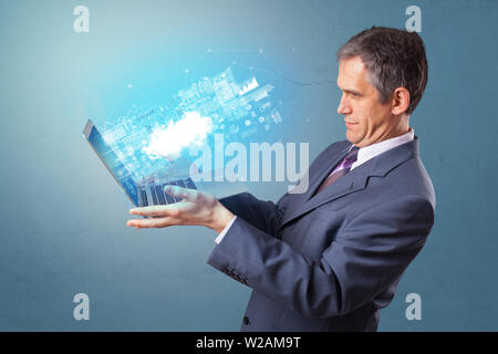 Man holding laptop projecting notifications, symbols and information based on cloud technology system Stock Photo