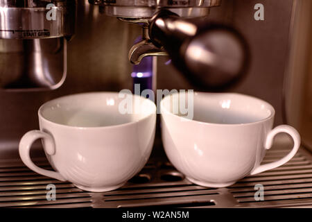 Espresso Machine Pouring Coffee In Two Shot Glass Stock Photo