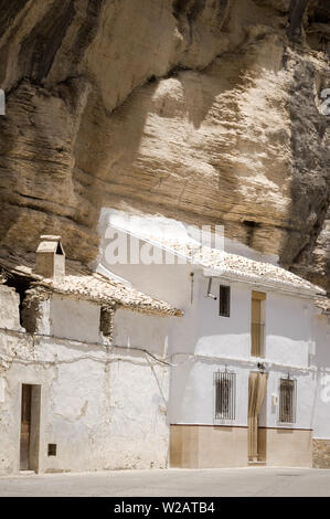 White houses built into rock in Setenil de las Bodegas, Cadiz, famous white town (Pueblos Blancos) of Andalusia, Spain. Touristic village on sunny day Stock Photo