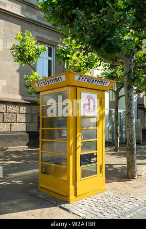 Frankfurt, Germany. July 2019.   An ancient yellow Phone Booth in the city Stock Photo