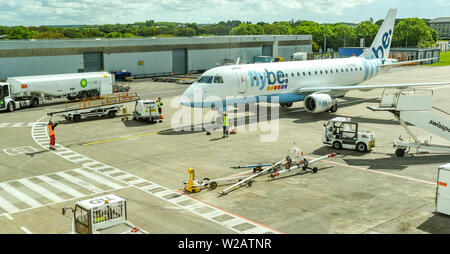 CARDIFF WALES AIRPORT - JUNE 2019:  Embraer E175 jet operated by Flybe being marshalled to its stand at Cardiff Wales Airport. Stock Photo