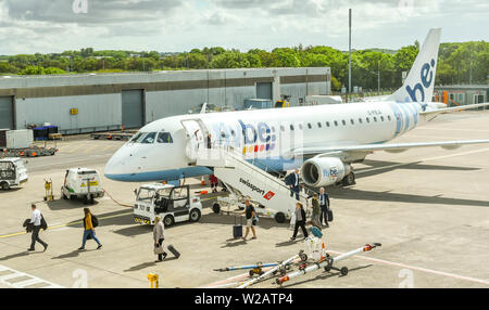 CARDIFF WALES AIRPORT - JUNE 2019: Passengers disembarking an Embraer E175 jet operated by Flybe at Cardiff. Stock Photo