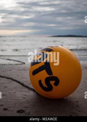 Rhosneigr, Wales, UK - A buoy sits on Traeth Cymyran beach. Stock Photo