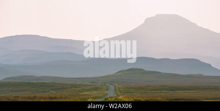 Isle of Skye - misty island landscape - hills silhouette covered in mist Stock Photo