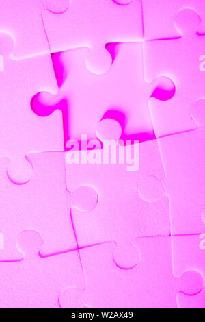 Multiple white puzzle pieces put together without one piece. View from above. Stock Photo