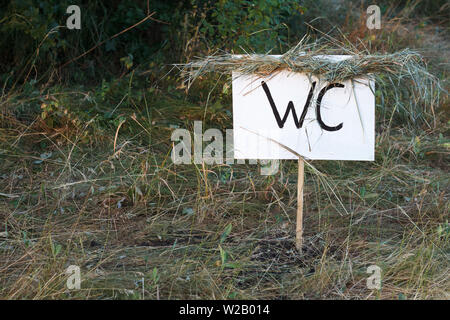 Simple design handmade wooden sign of toilet give direction to WC Stock Photo